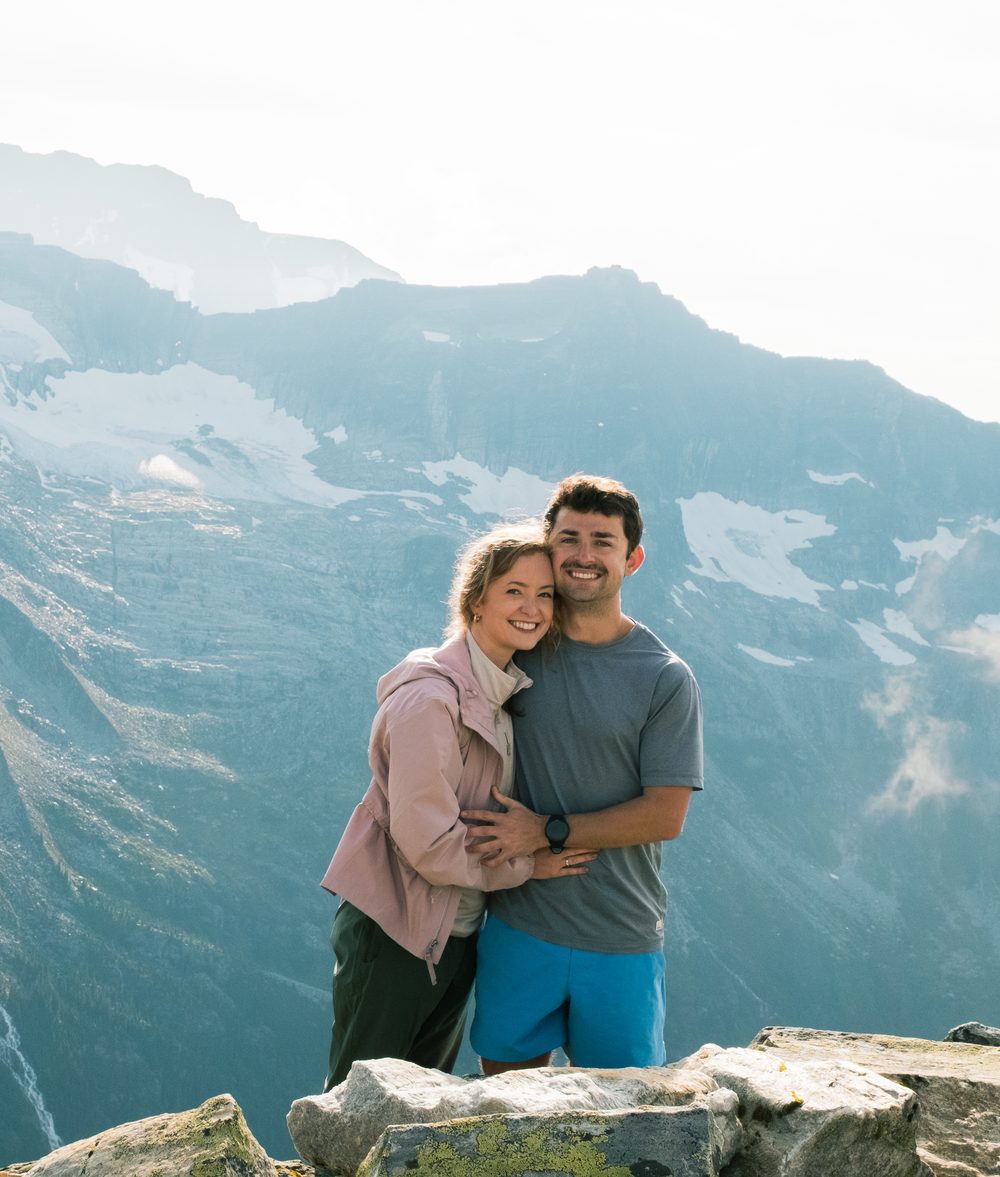 Caleb and Jordan standing together on a rocky overlook in the Canadian mountains